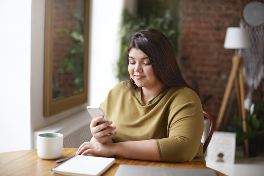 plus size woman reading on cell phone