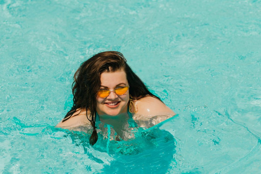 plus size woman swimming in a pool