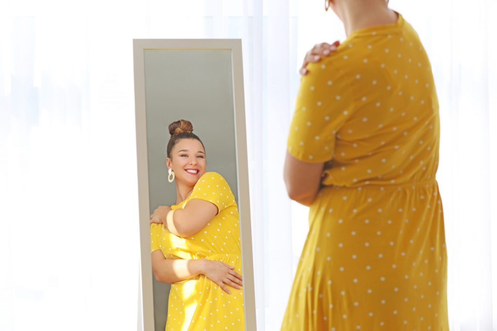 Young woman looking in mirror