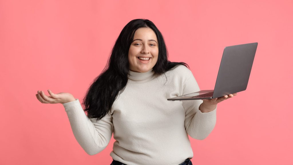 plus size woman researching on laptop