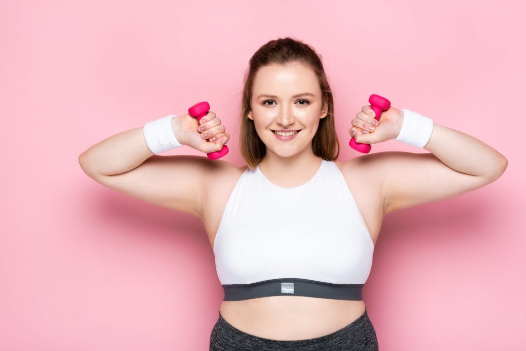 Young woman lifting weights