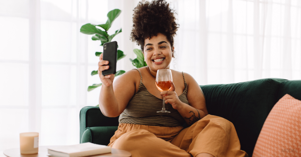 Women drinking alcohol on couch after Weight Loss Surgery (model)