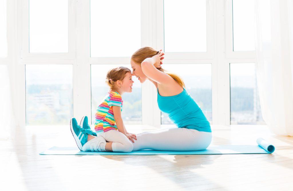family mother and child daughter are engaged in fitness