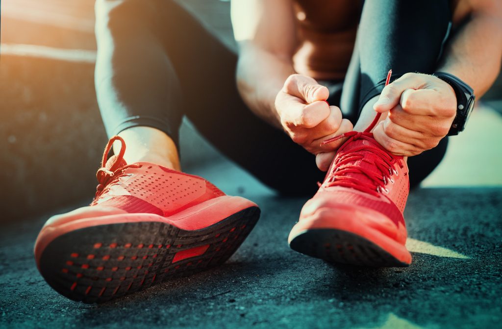 Lady tying up running shoes