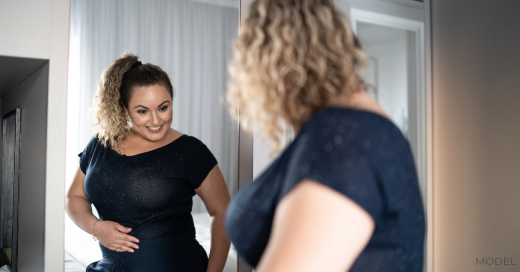 Woman in front of a mirror at home after LAP-BAND® surgery (model)