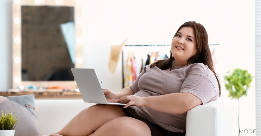 Overweight women researching weight loss options (model)
