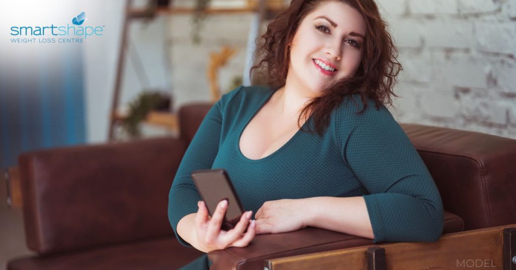 Woman reading about how to prepare for weight loss surgery (model)